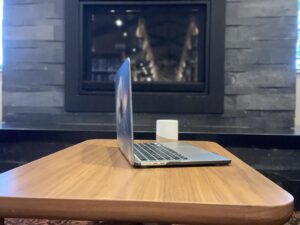 Open laptop on desk with mug, staged for online therapy session.